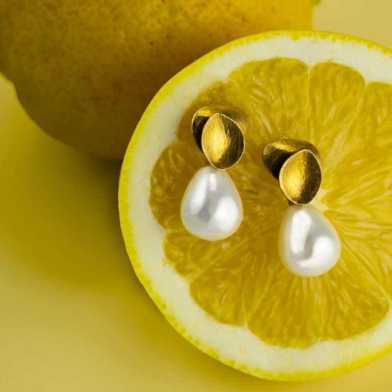 Pearl earrings on lemon